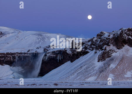 Seljalandsfoss, 66 m high waterfall situated on the river Seljalandsá at night in winter, Rangárþing eystra, Iceland Stock Photo