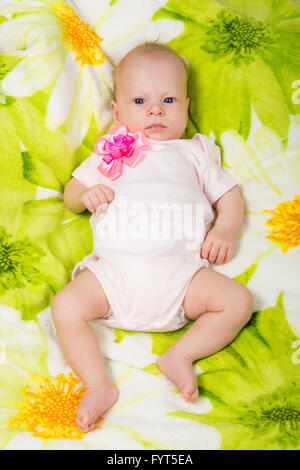 The two-month baby lying on the bed on his back looking at the frame Stock Photo