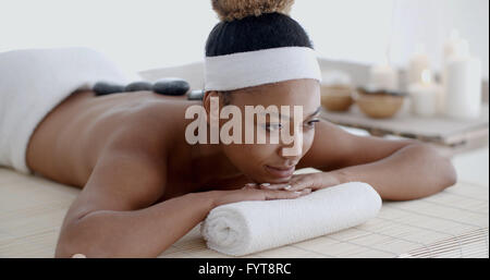 Woman Getting Hot Stones Massage At Spa Stock Photo
