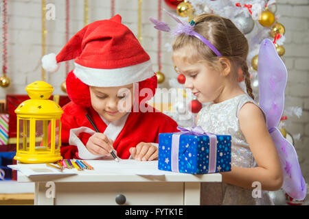 Father Frost wrote a congratulatory letter to the assistant fairy standing next Stock Photo