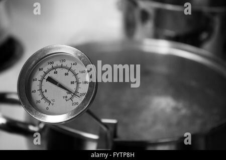 Boiling Water in Pot with Thermometer in Black and White.  Part of Home Brewing Series. Stock Photo