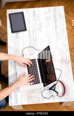 Young man typing on his laptop Stock Photo