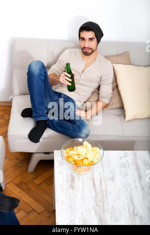 Young man drinking beer Stock Photo