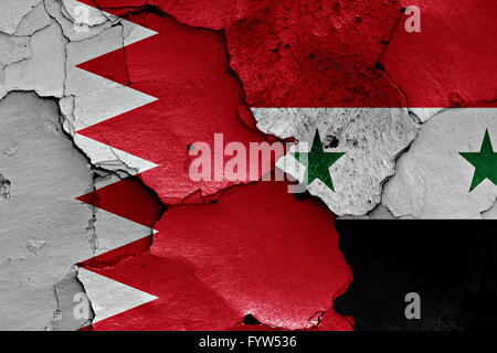 flags of Bahrain and Syria painted on cracked wall Stock Photo