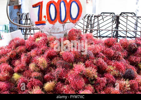 Pile of rambutan fruits with a price tag in the market of San Jose, Costa Rica Stock Photo