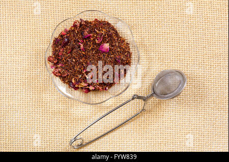 Rooibos with cranberry fruit, dry herbal tea called bush tea, Aspalathus linearis made from needle like leaves, mixed with rose Stock Photo