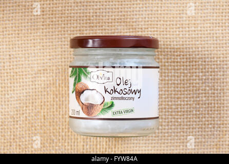 Extra virgin coconut oil from Olvita Polish firm, fat food ingredient product for frying, baking, roasting or spreading. Stock Photo
