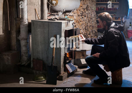 Fireplace with firewood burning furnace or kiln, house cellar interior in the country home, the underground basement room. Stock Photo