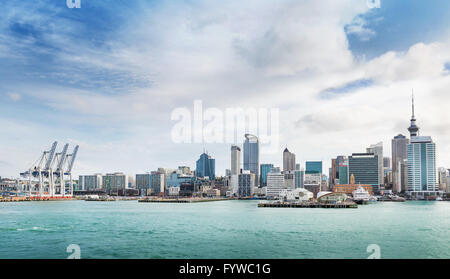 skyline of Auckland with city central business district and port cranes at cloudy noon Stock Photo