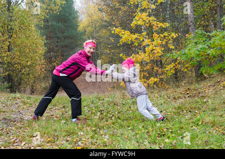 Woman with girl doing aerobics in the park Stock Photo