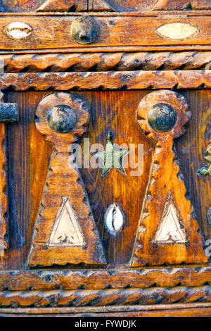 grey metal rusty      morocco in africa the old wood  shell padlock Stock Photo