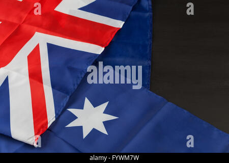 Folded Australian flag on black background with copy space Stock Photo