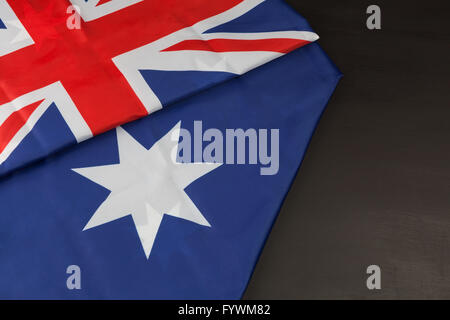 Folded Australian flag on black background with copy space Stock Photo