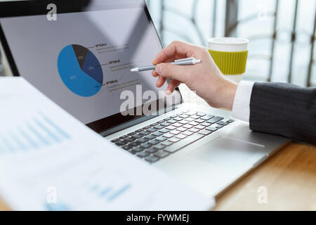 businessman checking financial reports on table Stock Photo