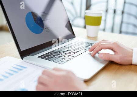 businessman checking financial reports on table Stock Photo