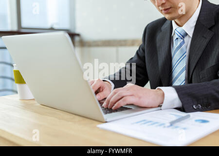 businessman checking financial reports on table Stock Photo