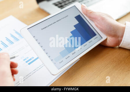 businessman checking financial reports on table Stock Photo