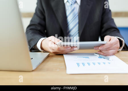 businessman checking financial reports on table Stock Photo