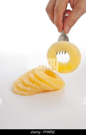 slice of pineapple on a fork Stock Photo