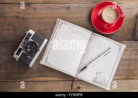 Notebook Camera and Coffee Stock Photo