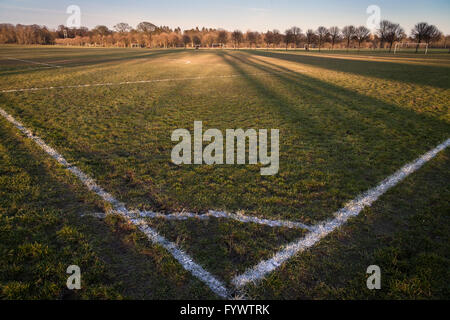 Sunset and shadows over a football pitch in Cardiff, UK Stock Photo