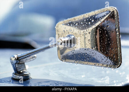 Car wing mirror in the rain, 1970 Stock Photo