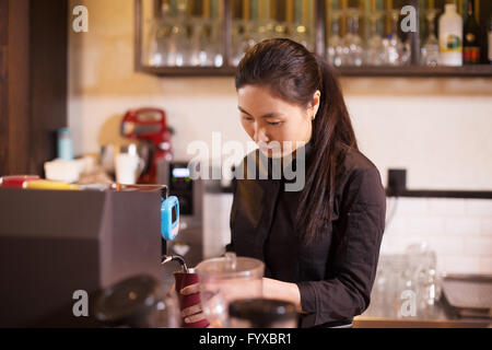 waitress serving in modern cafe Stock Photo