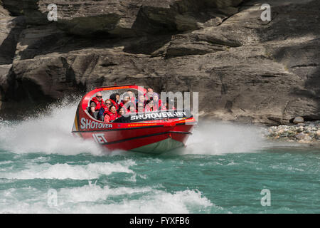 Group of tourists Jet boating on Shotover River at Arthurs Point, Queenstown, Otago, New Zealand's South Island.