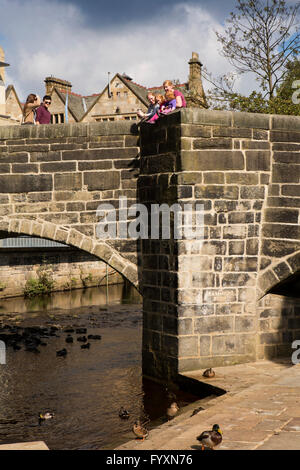 UK, England, Yorkshire, Calderdale, Hebden Bridge, young family enjoying view from old packhorse bridge Stock Photo