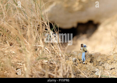 backpacker miniature stand in nature Stock Photo