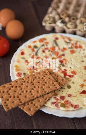 baked omelette with different eggs and vegetables Stock Photo
