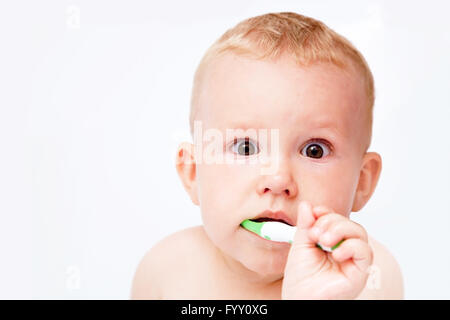 Baby cleaning teeth Stock Photo