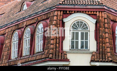 Mansard windows on a tile roof of the house in Tallinn, a close up Stock Photo