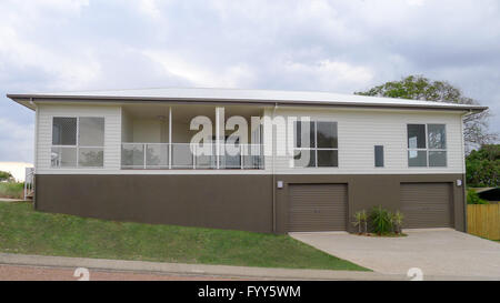 Two story modern house brown and white exterior with deck at front Stock Photo