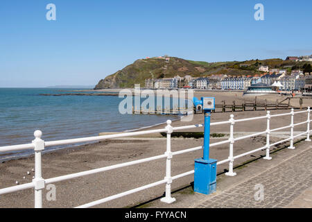 Owl telescope on seafront promenade overlooking north beach with Constitution Hill above in Cardigan Bay. Aberystwyth Wales UK Stock Photo