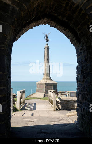 War Memorial on Castle Point framed by arch in Porth Newydd or New Gate of 13thc Castle ruins in Cardigan Bay. Aberystwyth Wales Stock Photo