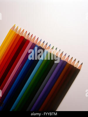 Multi-coloured pencils in a line, inside. Stock Photo