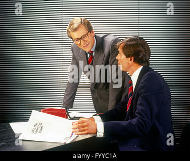 Two business men discussing in an office, inside. Stock Photo
