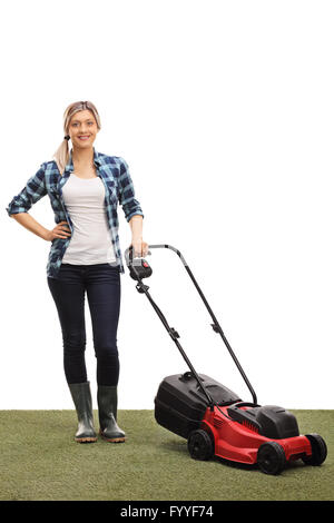 Vertical shot of a young woman posing with a lawnmower isolated on white background Stock Photo