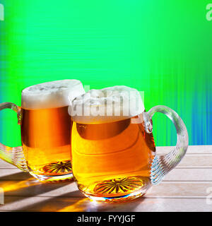 two beer on the table with modern green background Stock Photo