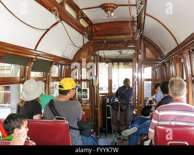 Tourists inside vintage tramcar of heritage tram line in Porto, Portugal Stock Photo