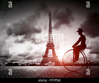 Man on retro bicycle next to Effel Tower Stock Photo