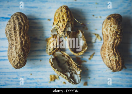 Fresh peanuts in shell on blue desk Stock Photo