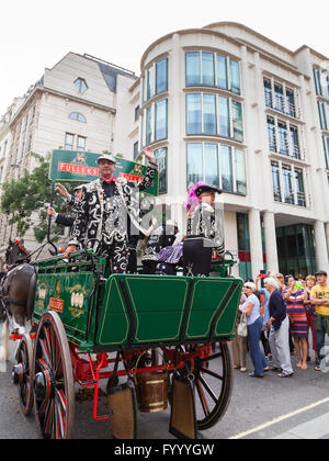 Shaun Austin, the Pearly King of Tower Hamlets, waves from an old Fuller's brewery wagon at the annual Pearly Kings and Queens A Stock Photo