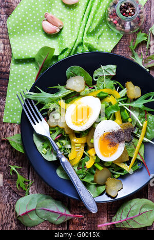 salad with eggs on plate and on a table Stock Photo