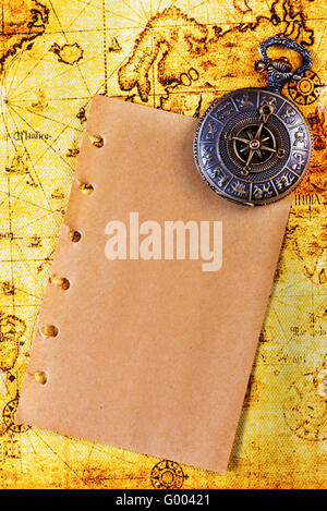 old notebook, loupe and compass on the map Stock Photo