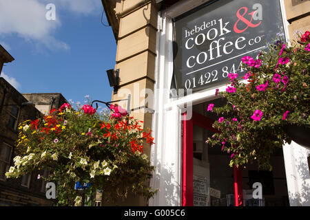 UK, England, Yorkshire, Calderdale, Hebden Bridge, Albert Street, Hebden Cook and Coffee Co floral hanging baskets Stock Photo