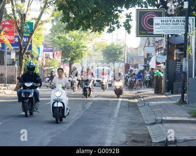 Heavy traffic of scooters and motor bikes on the streets of Bali. Stock Photo