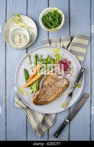 Saithe fish with Wakame and Vegetable Stock Photo