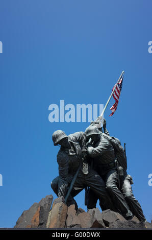 ARLINGTON, Virginia, United States — The Marine Corps War Memorial, also known as the Iwo Jima Memorial, stands prominently in Arlington, Virginia, just outside Washington, DC. The bronze statue depicts six Marines raising the American flag on Mount Suribachi during the Battle of Iwo Jima in World War II, based on the iconic photograph by Joe Rosenthal. Stock Photo